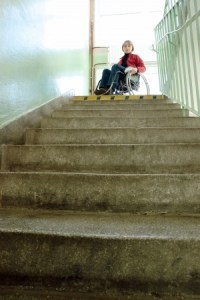 Lady in wheelchair at top of stairs unable to exit building