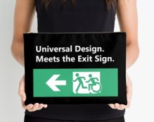 Lady holding a bag with the Universal Design Meets the Exit Sign wording on it, with a green exit sign showing person running followed by a person using a wheelchair, moving in the same style as the running person.