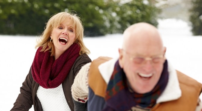 Senior couple enjoying themselves in winter forest